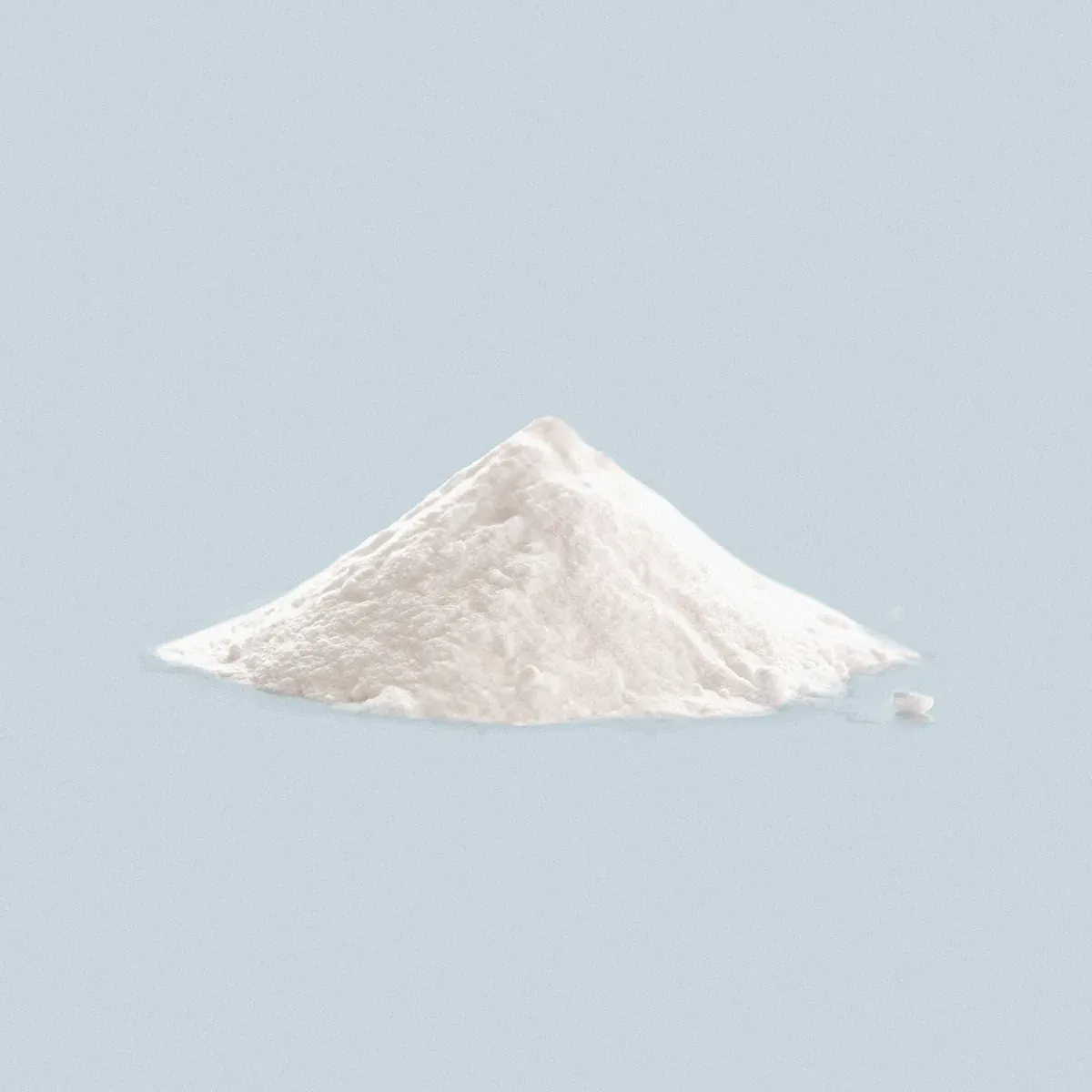 a pile of white powder sitting on top of a blue surface